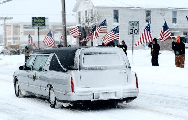 The hearse turns into the driveway at Christopher Mitchell Funeral Home in Albion. (Mark Gutman/Daily News)